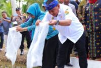Kadis Ketahanan Pangan Pemprov Sultra saat ini Pjs Bupati Koltim, Ari Sismanto (kanan) saat menabur bibit ikan. Foto (Istimewa).