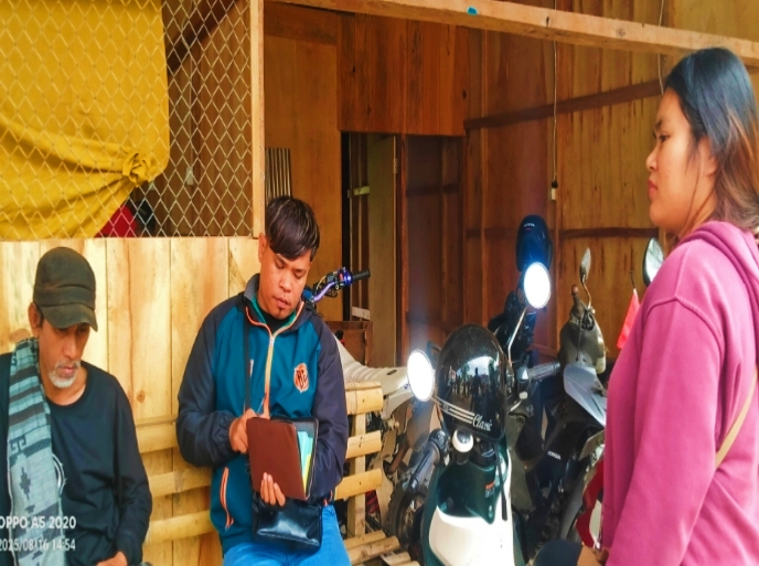 Rasid (kiri), warga yang ditagih koperasi saat duduk pasrah didatangi dua karyawan koperasi di rumahnya. (ist)